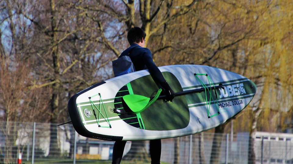 man carrying an SUP